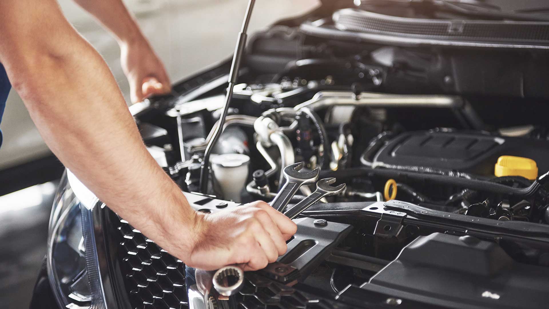 close-up-hands-unrecognizable-mechanic-doing-car-service-maintenance